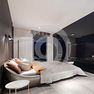 Stylish bedroom with black gloss wall