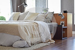 Stylish bedroom with white striped pillows on bed