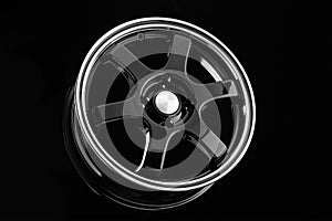 Stylish black die-cast disc for sports design cars on a black background.