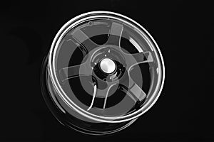 Stylish black die-cast disc for sports design cars on a black background.