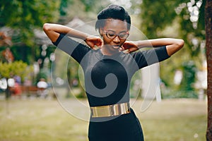 Stylish black girl in a park