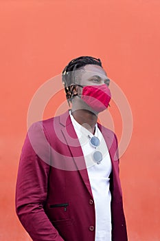 Stylish black man with mask to match his suit