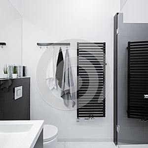 Stylish black radiator in bathroom