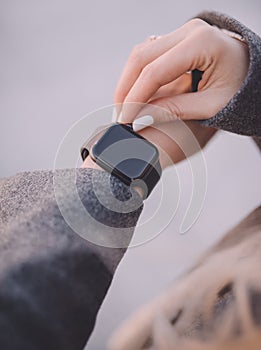 Stylish black smart watch on woman hand