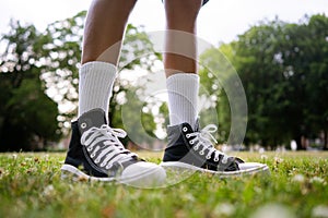 Stylish black sneakers on the grass