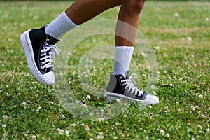 Stylish black sneakers on the grass