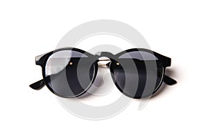 Stylish black sunglasses isolated on white background, top view