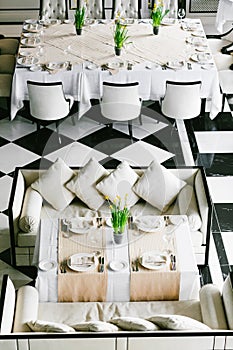 Stylish black and white dining tables and chairs. Minimalist interior in monochrome. Empty restaurant top view. photo