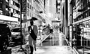 Stylish black and white wet New York NYC commuter with umbrella