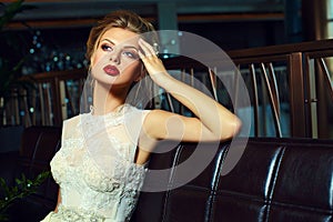 Stylish blond bride girl model in wedding dress