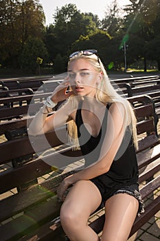 Stylish blonde model in casual outfit wearing sunglasses