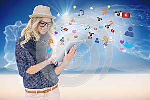 Stylish blonde using tablet pc with app icons