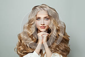 Stylish blonde woman with healthy hair on white background