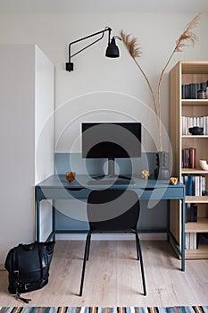 Stylish blue desk in simple study room