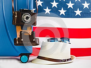 Stylish, blue suitcase, USA flag and vintage camera