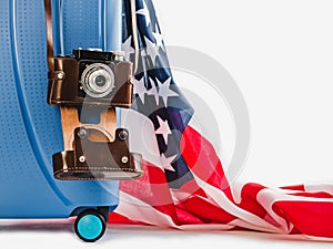 Stylish, blue suitcase, USA flag and vintage camera