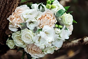 Stylish boho rustic wedding bouquet on wooden branches outdoors