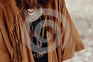 Stylish boho woman look. gypsy hipster girl in fringe jacket wit