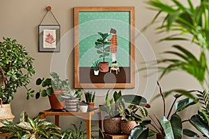 Stylish botany composition of home garden interior with wooden mock up poster frame, filled a lot of beautiful house plants.