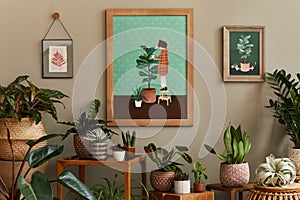 Stylish botany composition of home garden interior with wooden mock up poster frame, filled a lot of beautiful house plants.