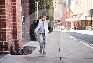 A stylish boy walking in a city