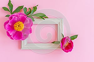 Stylish branding mockup to display your design. mock up on pastel pink background made of photo frame and blooming peony flowers.
