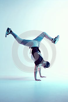 Stylish breakdancer stands on hands dancing hip-hop in neon light. Dance school poster. Battle competition announcement