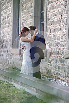 Stylish bride and groom at a park on their wedding day. Beautiful love story in nature, couple in love