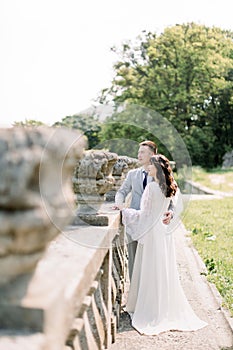 Stylish bride and groom. wedding couple. Happy bride and groom on their wedding day. Groom and Bride walking near old