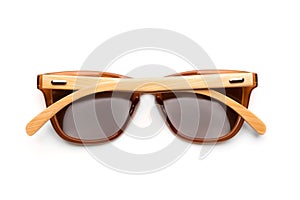 Stylish brown sunglasses with wooden frames isolated on white background.