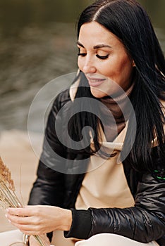brunette girl in leather jacket and sweater with throat autumn clothes