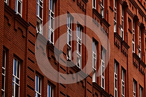 Stylish building made of old brick with modern, energy-saving metal-plastic windows. Urban style, restoration of old