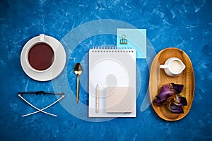 Stylish business flatlay mockup with knolled cup of black tea, notebook, glasses and pencil