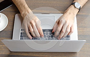 Stylish business man working on a laptop.