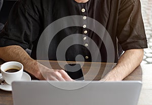 Stylish business man working on a laptop.