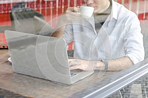 Stylish business man working on a laptop.