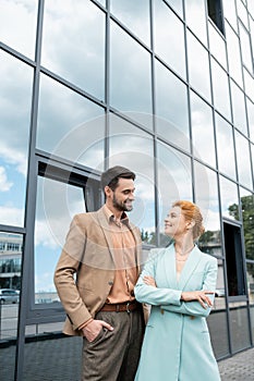 Stylish business people in blazers smiling