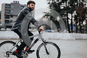 Stylish businessman commuting on a bicycle in an urban setting