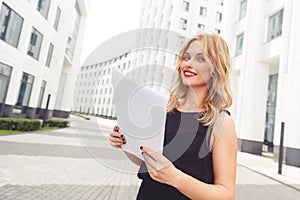 Stylish businesswoman with documents. Symbol of beauty and success