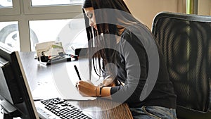 Stylish businesswoman sitting at his desk working