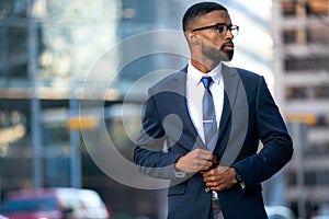 Stylish chic modern style business suit executive, african american male commercial model, walking to swanky office workplace