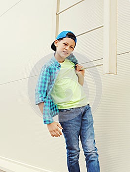 Stylish child boy wearing a shirt and baseball cap