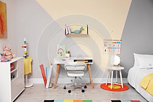 Stylish child room interior with bed and desk