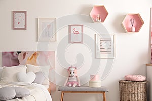 Stylish child`s room interior with beautiful pictures and comfortable bed