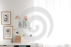 Stylish child`s room interior with desk and pictures. Space for text