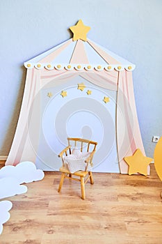 Stylish children`s room with a small chair and stars.