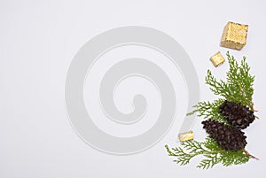 Stylish christmas composition. fir branches, cones and christmas gifts on white background. flat lay top view.