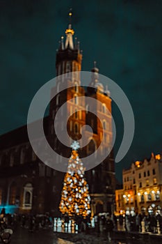 Stylish christmas golden illumination and Christmas tree. Krakow, Poland, Main Square and Cloth Hall in the winter