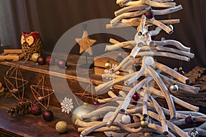 Stylish Christmas interior decorated in rustic style. Driftwood christmas