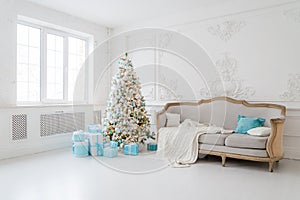 Stylish Christmas interior with an elegant sofa. Comfort home. Presents gifts underneath the tree in living room